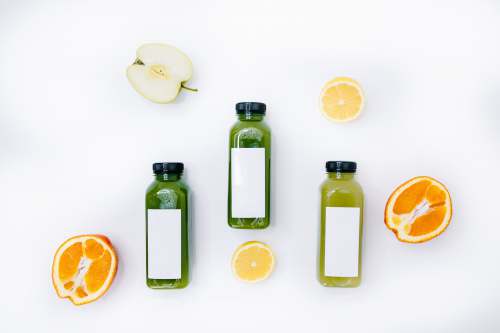 food background 3 bottles with sliced lemon and sliced orange fruits healthy lifestyle